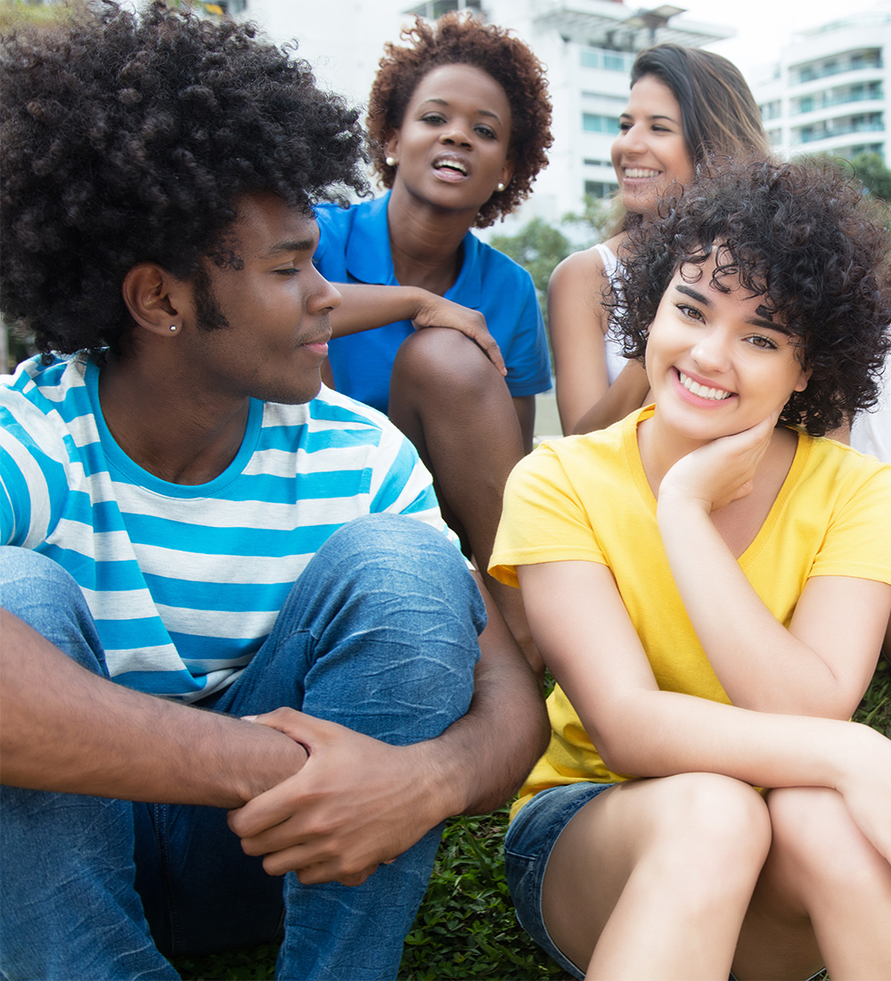 Niagara-youth-header Teens sit together outside in casual hangout; Niagara County Youth Services, BFNC Youth programs